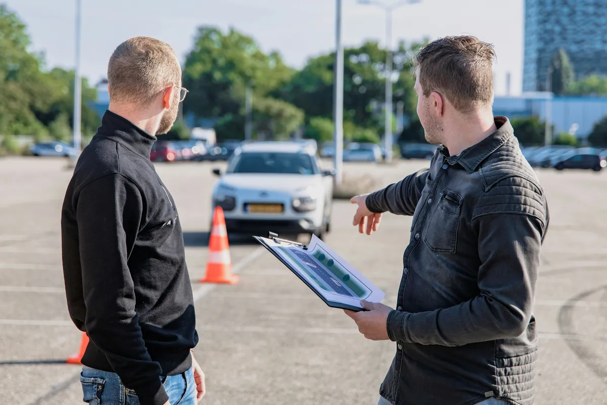 Driving test discussion in a car park